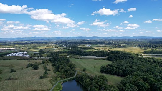 Facing east.  Interstate 81 runs across the middle of this shot, and the sign is to the right in the field (you'll probably need to click through to the enlargement to see it).