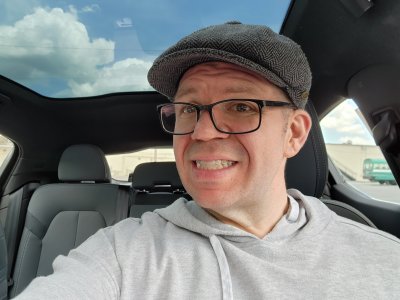 Selfie in the Polestar 2.  Note the full panoramic roof.  Note that while this is bigger than the moon roof that I have on the HR-V, this one doesn't open.