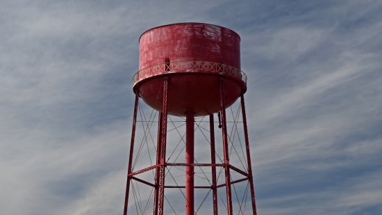 A red water tower.  I photographed it because it looked funny, appearing not to have a top.  As it turned out, based on Google Maps imagery, it really didn't have a top on it.