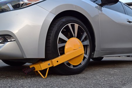 A car wearing a boot on its left front wheel