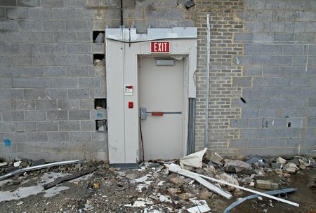 An intact emergency exit at Peebles, with demolition all around it.  If I recall, the wall separating the back room from the salesfloor ran through this area along one side of this door.