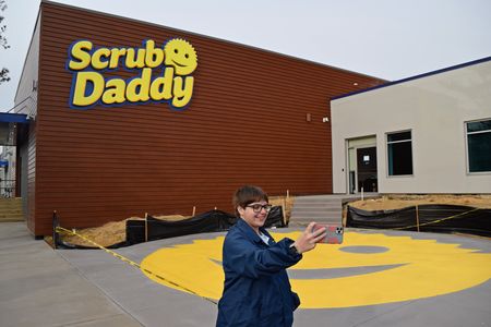 Elyse takes a selfie with the sign.