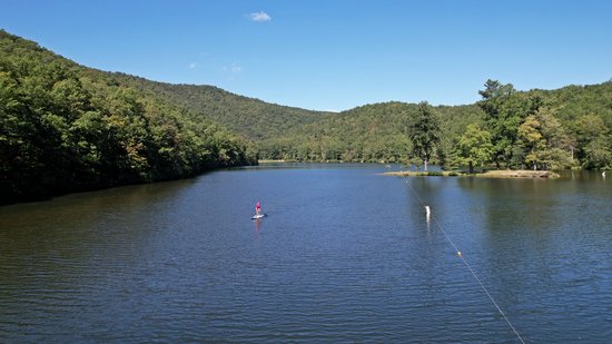 Another view of the lake, facing north.  A woman doing stand-up paddleboarding has come onto the water.