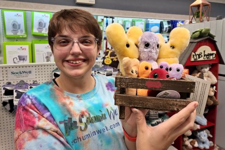 We then went to a local pharmacy, where Elyse posed for a photo with a basket of Giant Microbes toys.