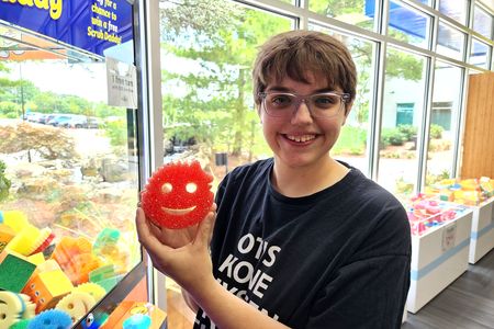 Elyse shows off what she won from the claw machine: a Scrub Mommy!