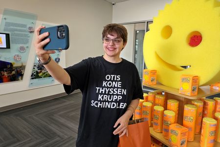 Elyse takes a selfie with the big Scrub Daddy.  One of the crab-shaped Scrub Daddy sponges is in the big Scrub Daddy's eye.