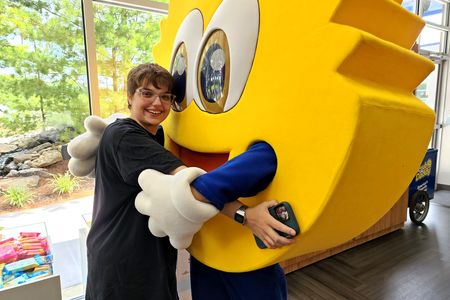 Elyse and the Scrub Daddy mascot share a hug.