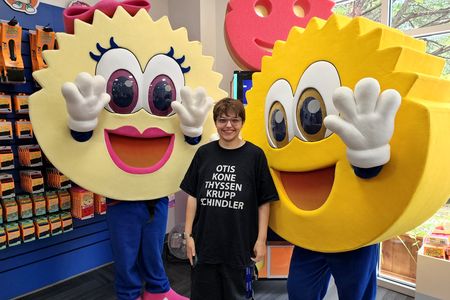 Elyse poses with the Scrub Daddy and Scrub Mommy mascot.