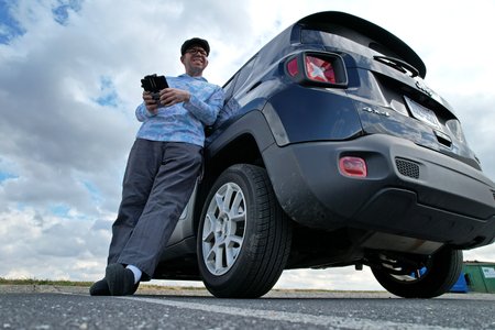 Selfie after landing, showing me standing with the rental car, a 2019 Jeep Renegade.