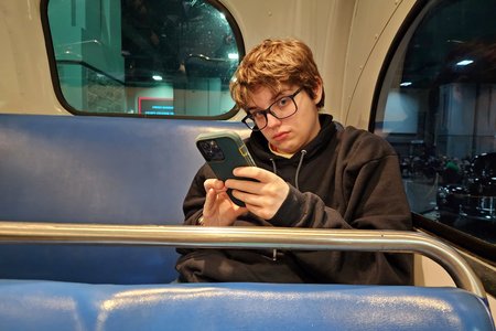 Busted: I was trying to get a candid photo of Elyse while looking at her phone in the back of the Rosa Parks bus.  She noticed me, and looked up just as I was taking the shot.