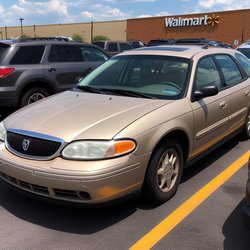 "Tan 2004 Mercury Sable station wagon in the parking lot at a Walmart store" (4)