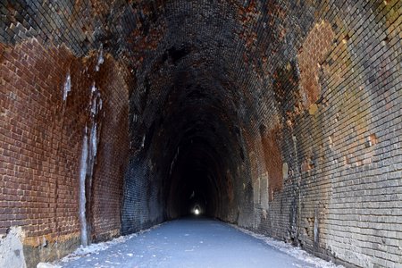 Looking down the tunnel from the west portal, with the east portal in the distance.