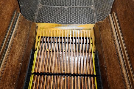 Wooden escalators at Macy's Herald Square. Similar to the width of the grooves, note the width of the teeth on the comb plate at the end of the escalator.