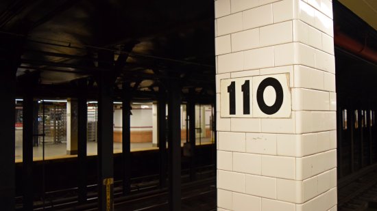 Station name signage on one of the columns along the downtown platform at Cathedral Parkway–110th Street station.