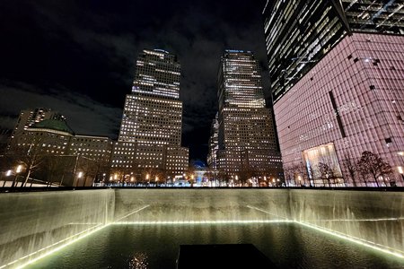 View across the North Tower pool, with One World Trade Center to the right, and the World Financial Center in the distance.