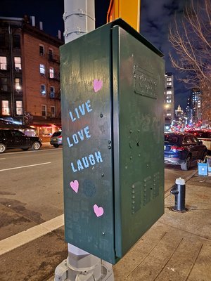 "Live, love, laugh" stenciled on a traffic signal box at the corner of 7th Avenue and Leroy Street.