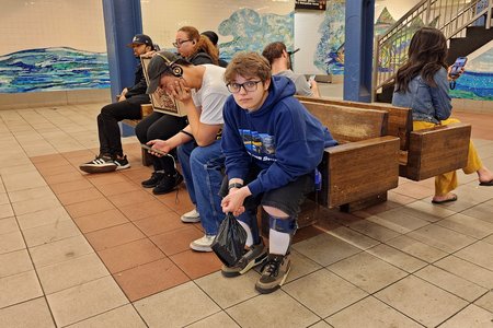 Elyse sits on a bench at Delancey Street while we wait for an F train back to Jay Street-MetroTech and then our hotel.