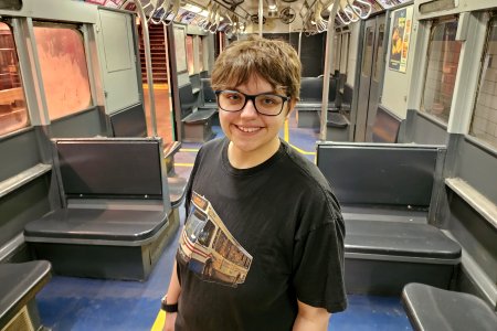 Elyse smiles for a photo on an R12 car.