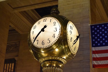 Clock atop a kiosk in the middle of the main atrium.