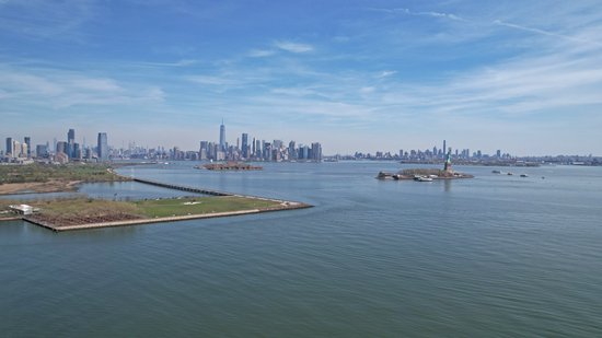 The Statue of Liberty, Ellis Island, and the New York skyline.