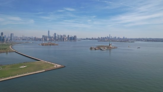 The Statue of Liberty, Ellis Island, and the New York skyline.