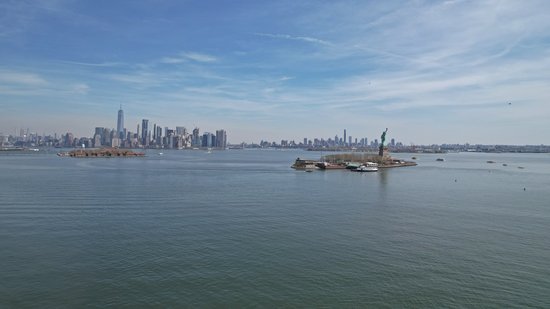 The Statue of Liberty, Ellis Island, and the New York skyline.