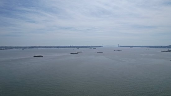 Facing the other way, with a lot of barges sitting in the river, and the Verrazzano-Narrows Bridge (which we went over on the way into New York) visible in the distance.