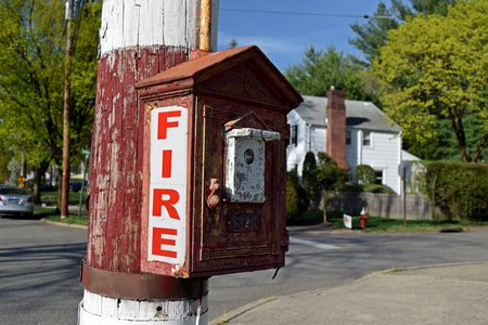 Gamewell fire alarm pull station mounted on a utility pole at the intersection of Northern Parkway and Downs Street.