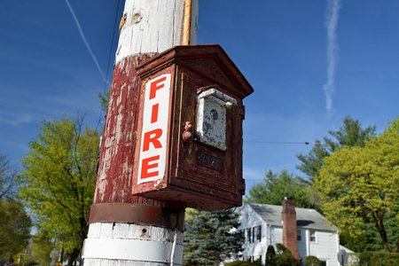 Gamewell fire alarm pull station mounted on a utility pole at the intersection of Northern Parkway and Downs Street.
