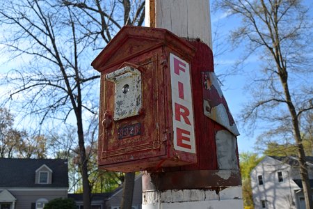 Gamewell fire alarm pull station mounted on a utility pole at the intersection of Northern Parkway and Downs Street.