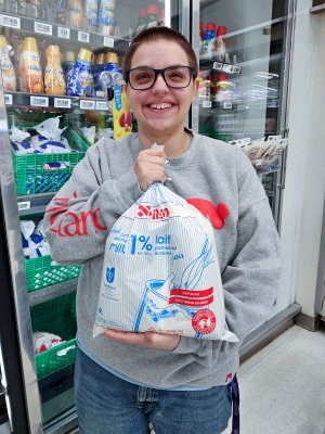 Elyse holds up a package of bagged milk at a Loblaws store.