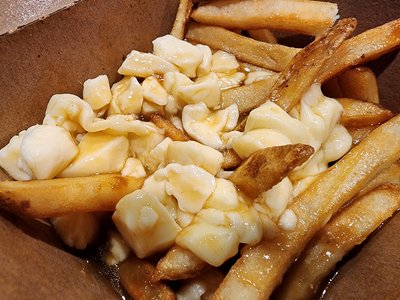 My poutine experience this time around.  We got this at Harvey's in Gatineau, which is a Canadian fast food chain.  Ordering was an interesting experience, as the menu was entirely in French, and the lady taking orders did not speak English.  I managed to get a burger and some poutine.