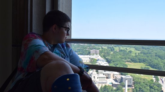 Elyse looks out of a window on the 36th floor of the Cathedral of Learning.