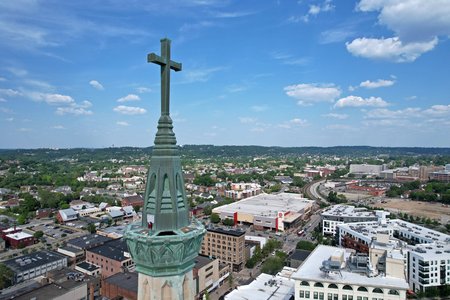 The cross at the top of the church's tower.