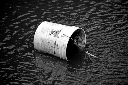 Discarded bucket in the canal.