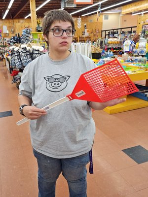 Elyse holds a giant novelty fly swatter.