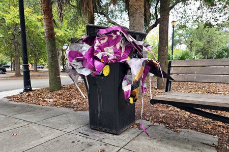 Properly disposing of the wrap material in a trash can in front of Kohl's.