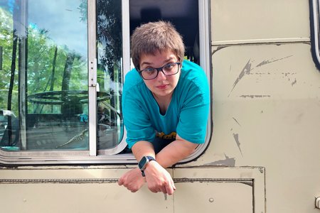 Elyse leans out of the driver's window for a photo after we finished unwrapping about two-thirds of the bus.