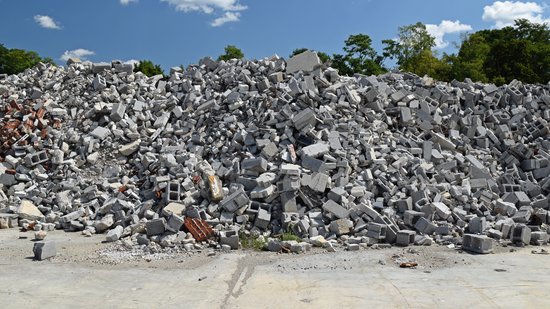 Debris pile on the east side of the former JCPenney building, mostly consisting of cinderblocks.
