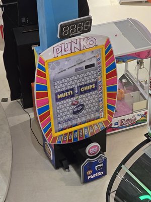 We briefly peeked in at Nickelodeon Universe, and I was surprised to find a Plinko game, like one would find on The Price is Right.  Normally, I've seen arcade games built in the spirit of Plinko with different theming, but never directly branded as Plinko.