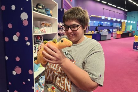 Elyse holds a toy dinosaur at Dream Live, which was hosting a place called "Bubble Planet" at the time of our visit.