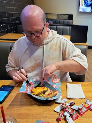 Kyle got this photo of me eating at the MrBeast Burger restaurant in the mall.  Both Kyle and Elyse found it interesting/disturbing that I dissected it, eating it with a knife and fork and consuming each ingredient separately rather than picking it up and eating it as a whole.