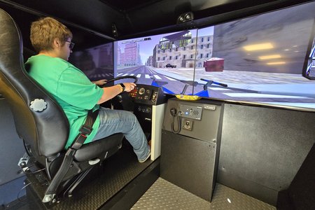 Elyse operates the bus simulator.