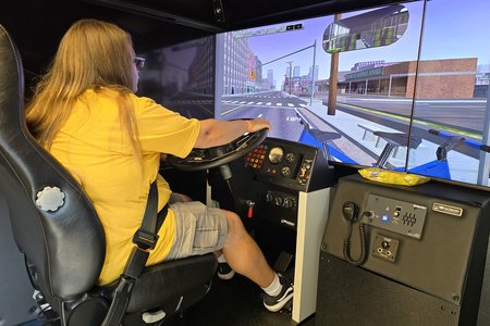 Kyle operates the bus simulator.