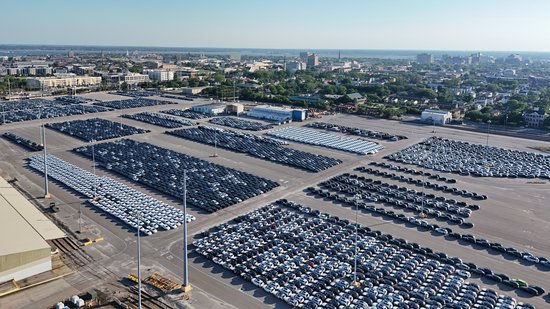 Rows upon rows of unsold cars, presumably freshly arrived in the USA.