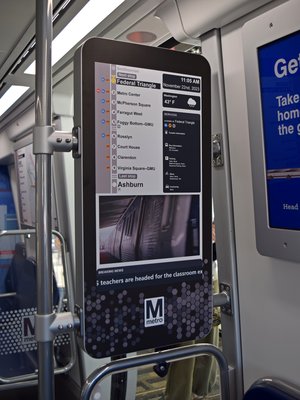 This digital screen, mounted perpendicular to the wall next to a door, is new on the 8000-Series.  The mockup shows an electronic strip map and a news feed.