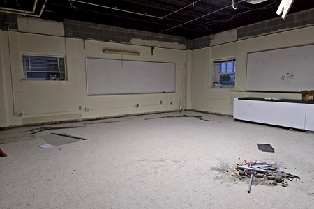 Gabbin Hall room G1 in March 2024, cleaned out with no lights or ceiling.