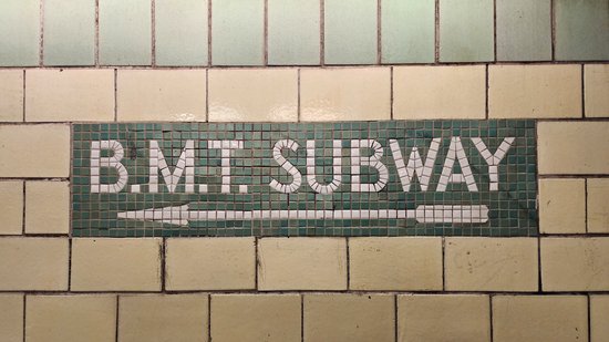 Tile mosaic signs at Fourth Avenue/Ninth Street station.