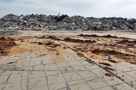 A large debris pile amongst a sea of floor tiles.