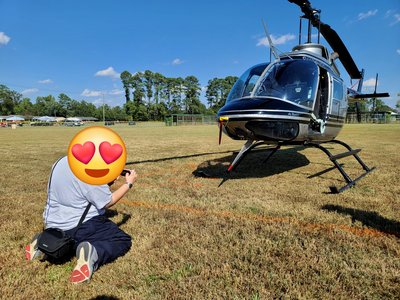 The helicopter photo, with an emoji sticker over Elyse's face